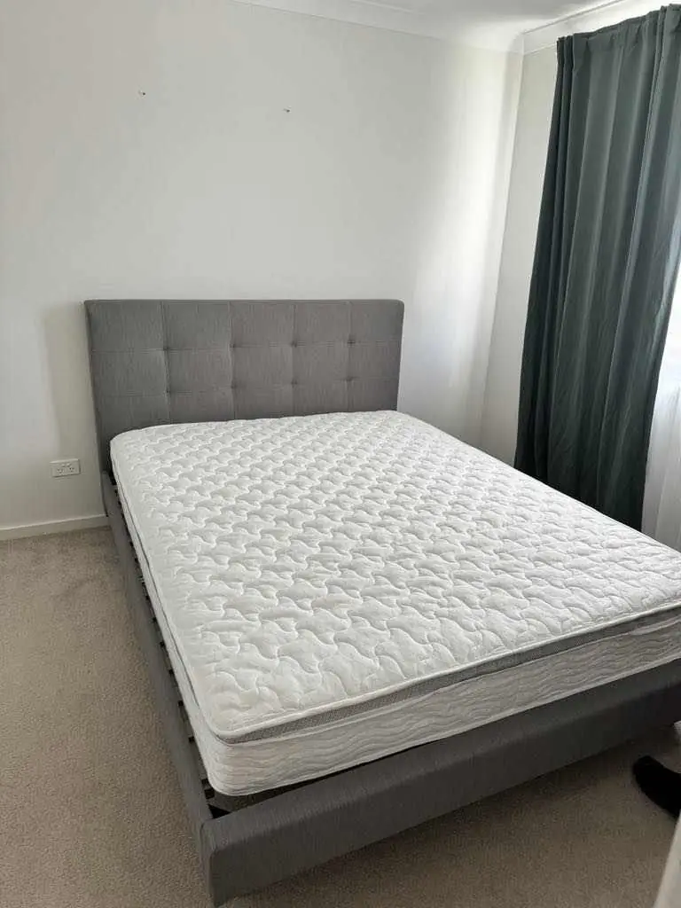 Finished upholstered bed frame with mattress