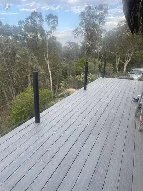 Grey composite balcony deck overlooking trees