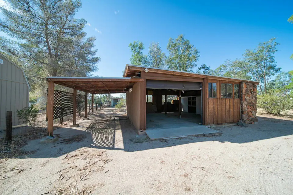 Timber carport beside a shed