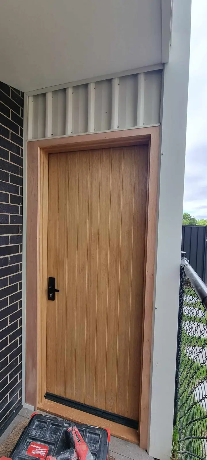 Timber entry door with black hardware