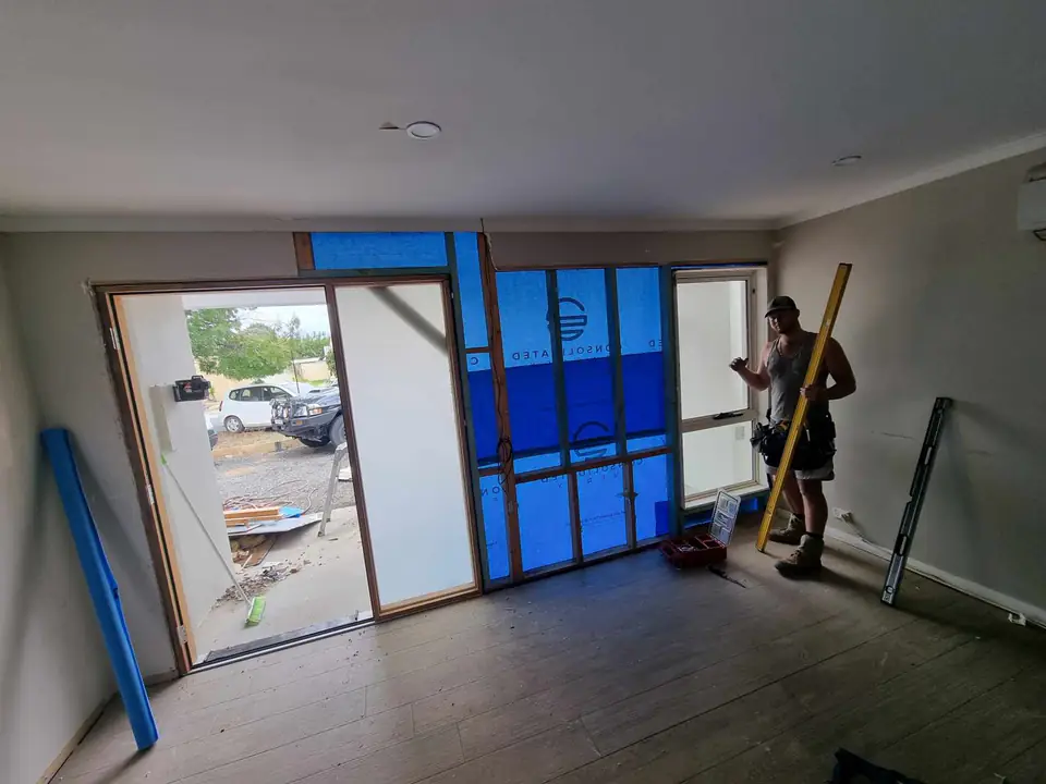 Framed opening with building wrap inside a living room